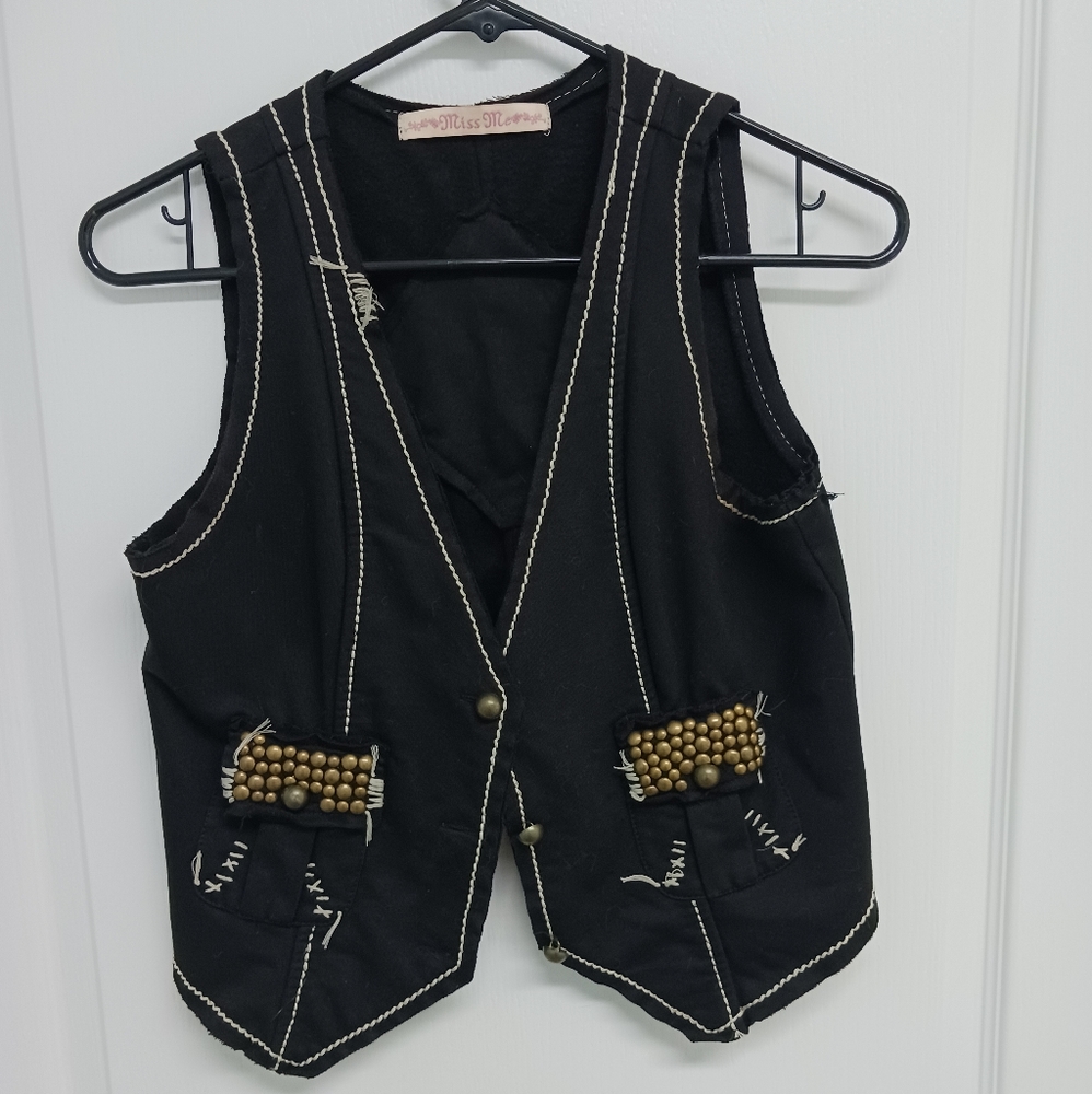 Miss Me black vest with muted gold embellishment. Size large, cut small.